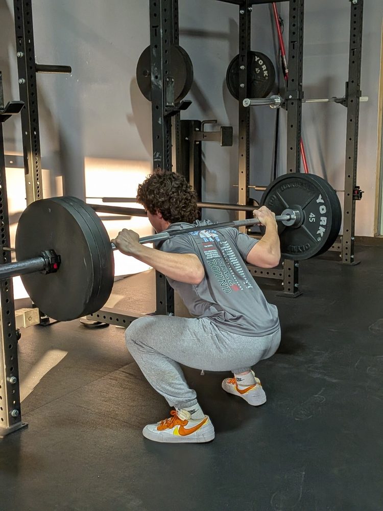 STC member performing a back squat