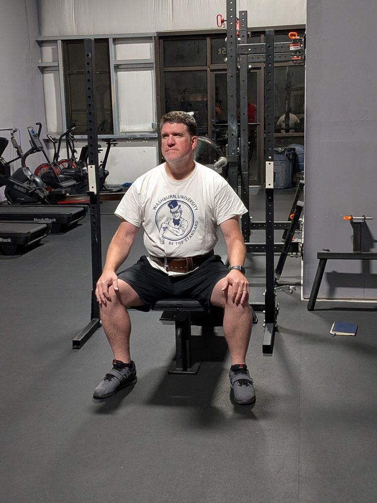 STC member with a lifting belt, seated on a bench